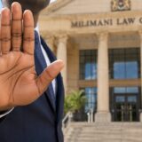 Advocate raising a hand in a stop gesture outside Milimani Law Courts, representing the need to file data protection complaints with the ODPC first